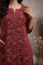 Close-up of kurti fabric and golden swirl print detail