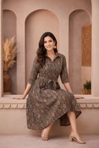 Seated pose in brown paisley patterned dress