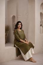 Seated pose in olive green kurti with embroidered yoke