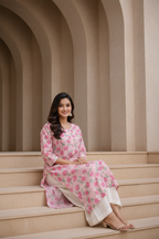 Seated pose in pink floral printed kurti with palazzo