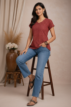 Seated pose in red chevron patterned top