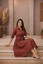 Seated pose in red medallion patterned dress