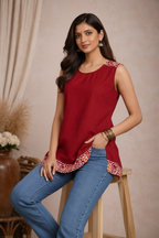 Seated pose in red sleeveless tunic top