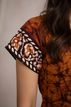 Side view of orange tie-dye tunic top