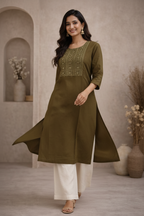 Walking pose in olive green kurti with embroidered yoke