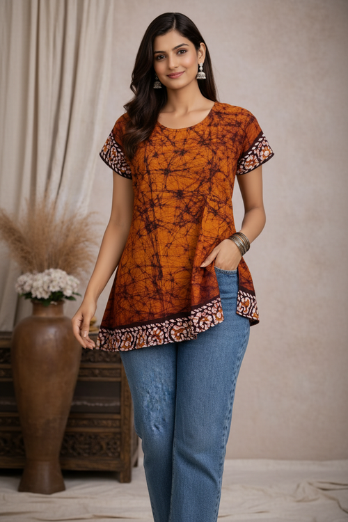 Walking pose in orange tie-dye tunic top