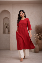 Walking pose in red kurti with embroidered yoke