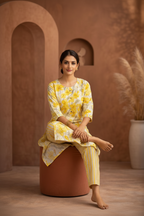 Yellow floral kurti seated pose